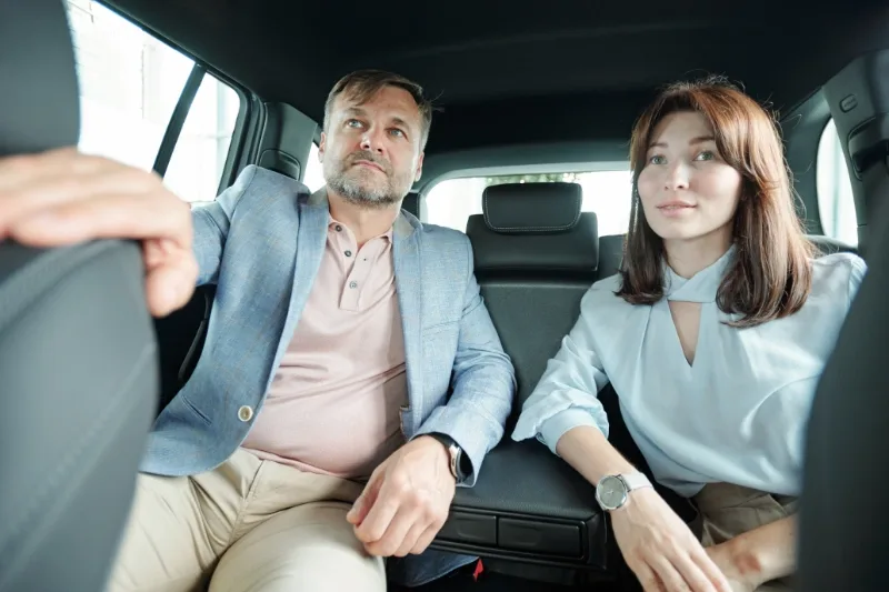 Two passengers traveling by car