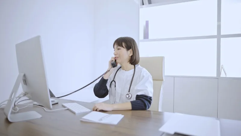 A clinician speaking by telephone